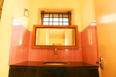 a bathroom with a mirror and a sink at KG Grand Inn in Erode