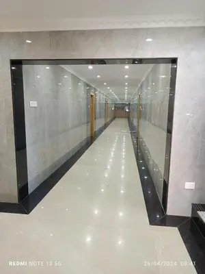 a hallway in a building with a long corridor at Arasan Residency in Kotagiri