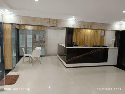 a lobby with a counter and chairs in a room at Arasan Residency in Kotagiri