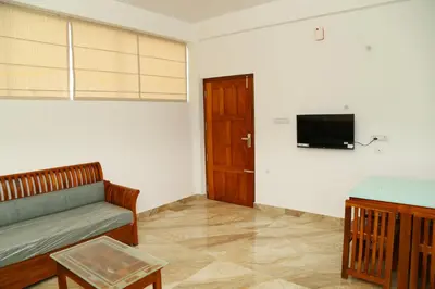 a living room with a couch and a tv at Shoreline in Kozhikode