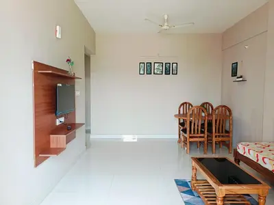 a living room with a couch and a tv at 2BHK Flat by SR Renton Comfort Homestay Mysore @ Vijayanagar 2nd stage Mysore in Mysore