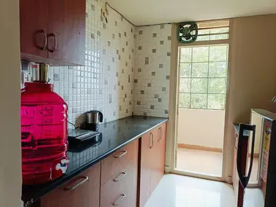 a kitchen with a red appliance on the counter at 2BHK Flat by SR Renton Comfort Homestay Mysore @ Vijayanagar 2nd stage Mysore in Mysore