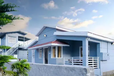 a blue house with a white at The Jade Highlands Mountain View 2 bhk Villa in Kodaikānāl