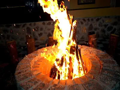 a large fire pit with flames in it at The Jade Highlands Mountain View 2 bhk Villa in Kodaikānāl