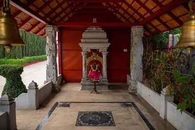 a shrine in a temple with a painting on it at Poojaris Nirantara - Mysuru in Hampāpura