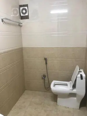a bathroom with a white toilet in a stall at Le Apex misty stay in Ooty