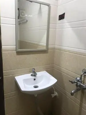 a bathroom with a white sink and a mirror at Le Apex misty stay in Ooty
