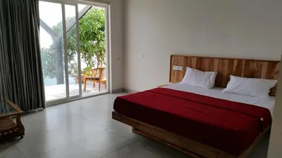 a bedroom with a bed and a large window at Mist View Resort Wayanad in Wayanad