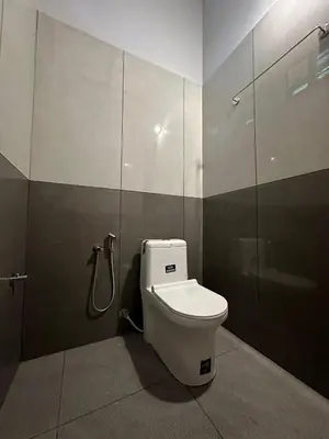 a bathroom with a toilet in a stall at Meghamalhar in Mānantoddy