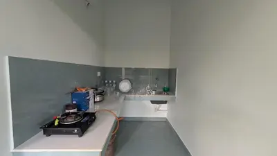 a small kitchen with a counter and a sink at Meghamalhar in Mānantoddy
