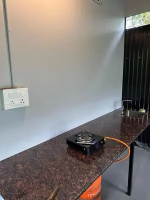 a stove on a counter in a kitchen at Meghamalhar in Mānantoddy