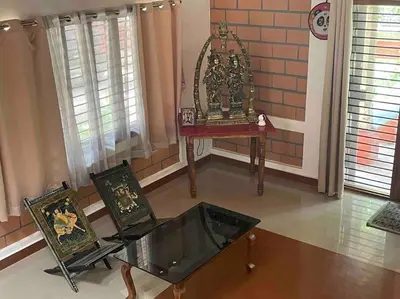 a room with a glass table and two chairs at 'Vrindavan' in Heritage City Mysuru in Mysore