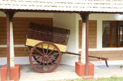 a wooden cart in front of a building at 'Vrindavan' in Heritage City Mysuru in Mysore