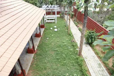 a garden with balls in the grass next to a fence at 'Vrindavan' in Heritage City Mysuru in Mysore