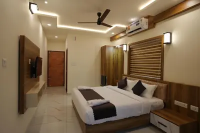 a bedroom with a large bed and a bathroom at M!steria Inn in Wayanad