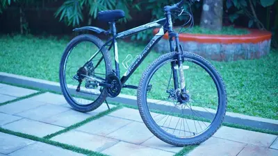 a bike is parked on a sidewalk at M!steria Inn in Wayanad