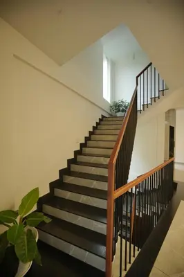 a staircase in a house with black treads at Sreeja Myst in Athirappilly