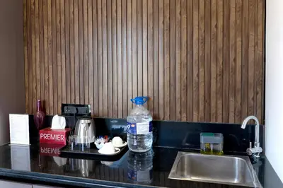a kitchen counter with a sink and a bottle of water at The Jade Highlands Mountain View Cozy container 2bhk villa in Kodaikānāl