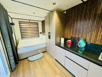 a small room with a bed and a counter at The Jade Highlands Mountain View Cozy container 2bhk villa in Kodaikānāl
