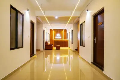 a hallway of a hospital with a couch in the background at Adam homes in Alwaye