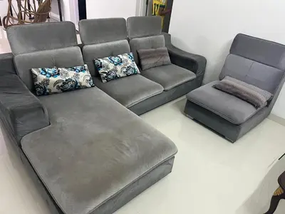 a couch and a chair in a living room at THEStay in Alwaye