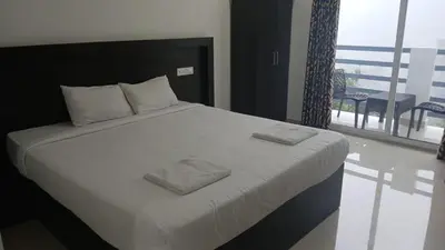 a bedroom with a bed with two towels on it at Karickanattu Nature Resort in Idukki