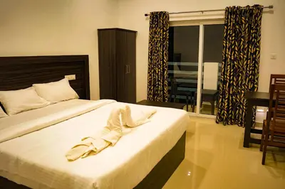 a bedroom with a bed with two shoes on it at Karickanattu Nature Resort in Idukki