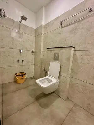 a bathroom with a toilet in a room at NIDRA INN in Kozhikode