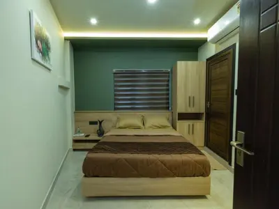 a bedroom with a large bed in a room at NIDRA INN in Kozhikode