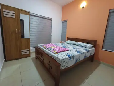 a bedroom with a bed in a room at Eden Homestays in Wayanad