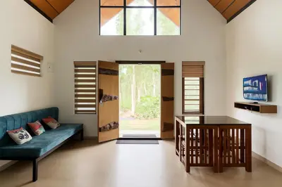a living room with a couch and a table at Senthamarai villa in Sultan Bathery