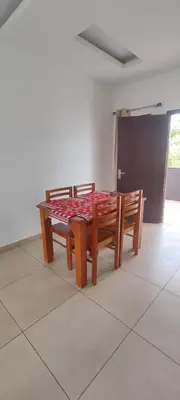 a wooden table and bench in a room at OOTY LIMRA HOLIDAY INN cottage in Ooty