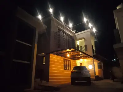 a car parked in front of a house at night at OOTY LIMRA HOLIDAY INN cottage in Ooty