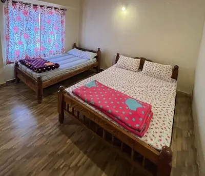 two beds sitting in a room with a window at cocostay coorg in Madikeri