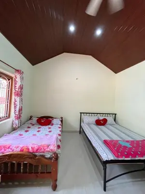 a bedroom with two beds in a room at cocostay coorg in Madikeri