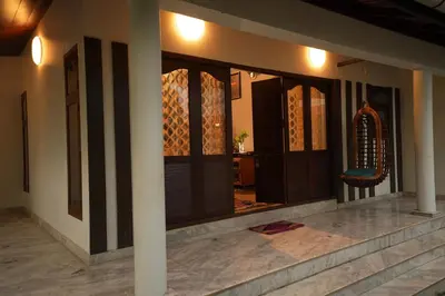 a house with a hallway with doors and a room at Bellevue Homestay and Wellness Centre in Kozhikode