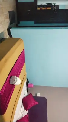 a room with a bed with a tv on top at Misty Stay by Le Apex in Ooty