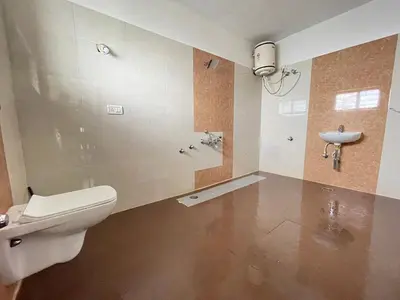 a bathroom with a toilet and a sink at ABODE Backpacker's Hostel in Madikeri