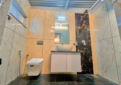 a bathroom with a sink and a toilet and a mirror at Vintage Inglenook Premium Heritage Bungalow Ooty by VOYE HOMES - A Quiet Retreat Close to Ooty Town in Ooty
