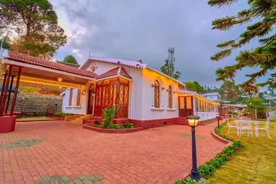 a house with a street light in front of it at Vintage Inglenook Premium Heritage Bungalow Ooty by VOYE HOMES - A Quiet Retreat Close to Ooty Town in Ooty