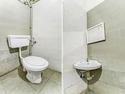 a bathroom with a toilet and a sink at Sri Balaji castle in Coimbatore