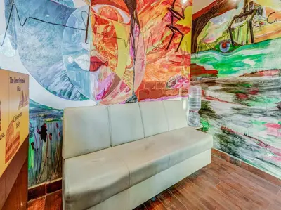 a room with a couch in front of a painting at Sri Balaji castle in Coimbatore