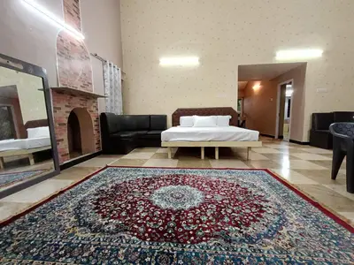 a room with a bed and a rug on the floor at Mountain View Private Villa in Ooty
