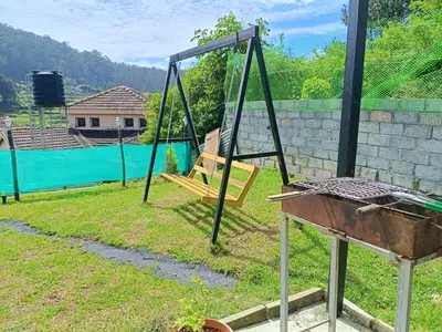 an empty swing set in a yard at Mountain View Private Villa in Ooty