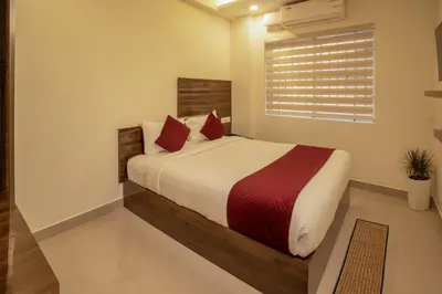 a bedroom with a large bed with red pillows at BR Residency in Trichūr