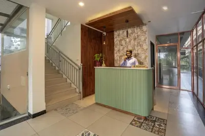a man standing at a counter in a house at BR Residency in Trichūr