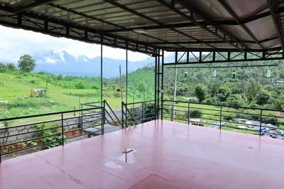 a large room with a view of a mountain at Iyer Square in Attappādi