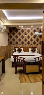 a bedroom with two beds in a room at Alicos Residency in Sultan Bathery