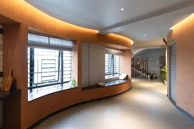 a hallway with two large windows in a building at YMCA International Guest House in Trichūr