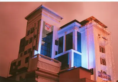 a building with blue lights on the side of it at YMCA International Guest House in Trichūr